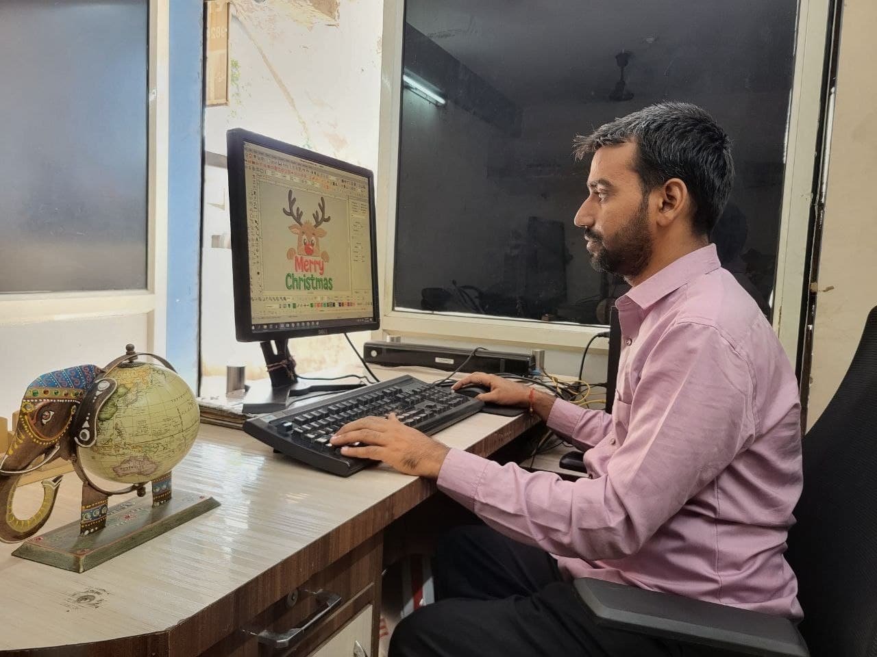 Ghanshyam digitizing an embroidery design on computer